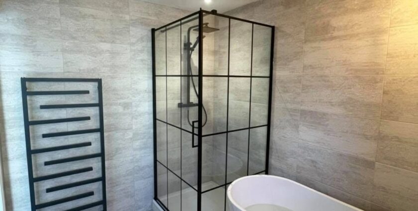 Modern bathroom with a black-framed walk-in shower enclosure, complete with a rainfall shower system and minimalist black fixtures.
